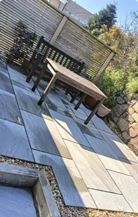 New sandstone patio with garden furniture — Devon’s Landscaping